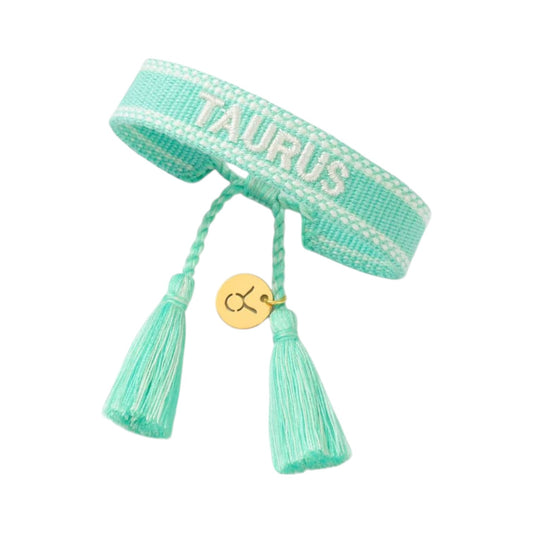 Bracciale in tessuto turchese con scritta Taurus e charm